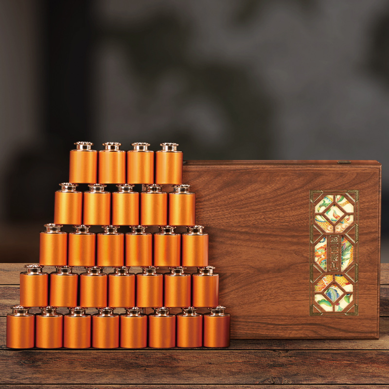 Thirty small tea tins and wooden box